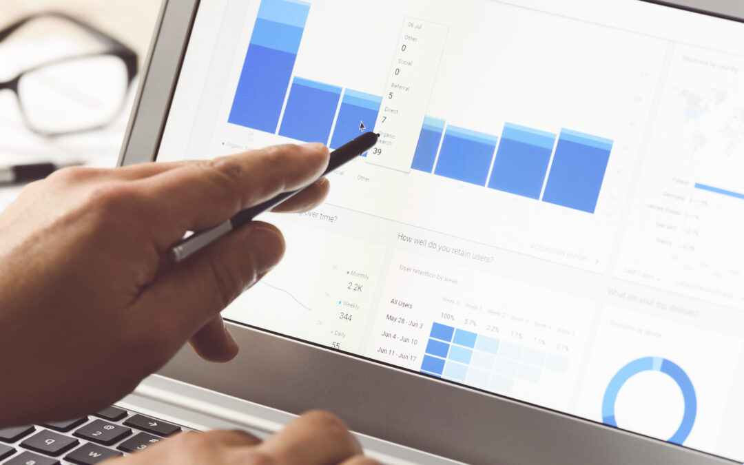 Businessman using internet analytics in the office on the touch screen of his laptop.