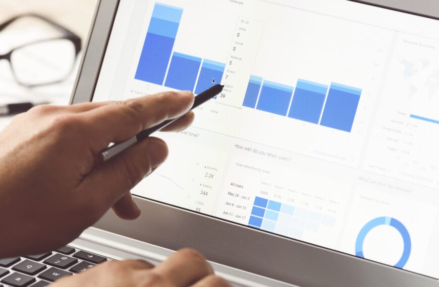 Businessman using internet analytics in the office on the touch screen of his laptop.