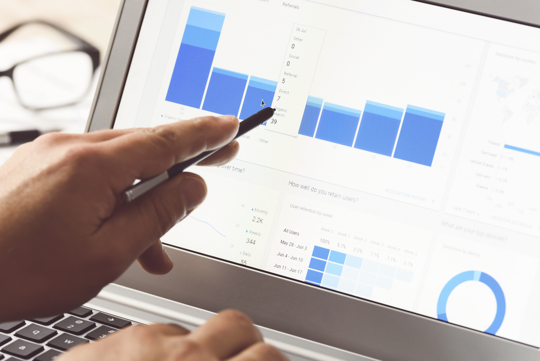 Businessman using internet analytics in the office on the touch screen of his laptop.