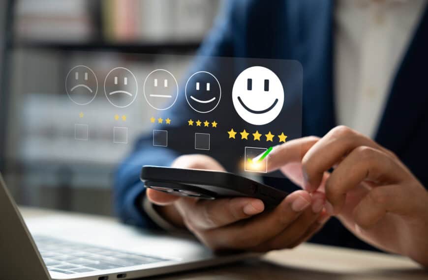 Positive customer review concept; Person using a smartphone to rate small business from one star to five.